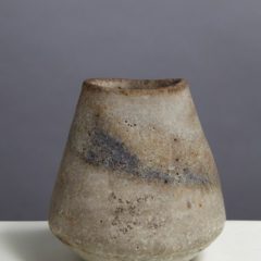 Abstract vase with light grey textured surface